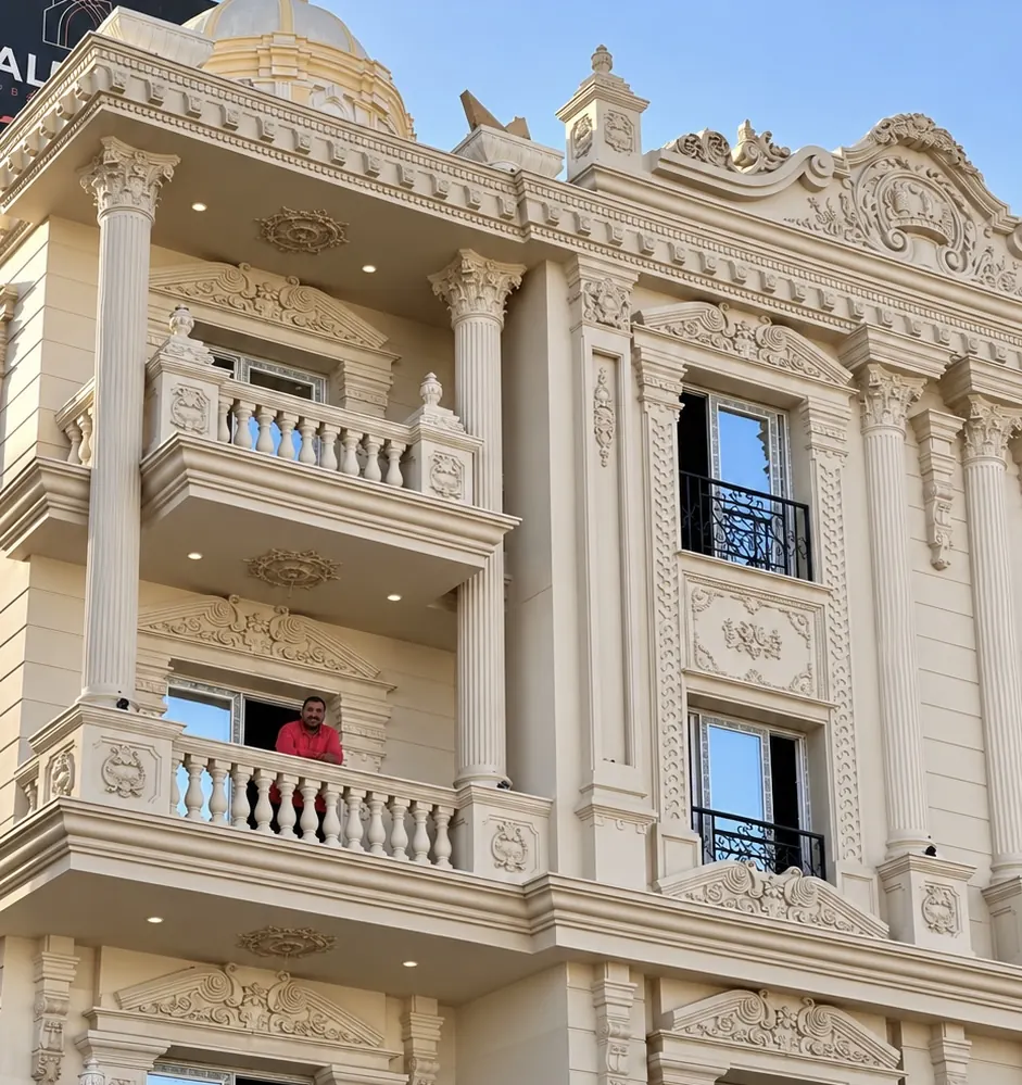 Façade with balustraded balconies and carved window surrounds