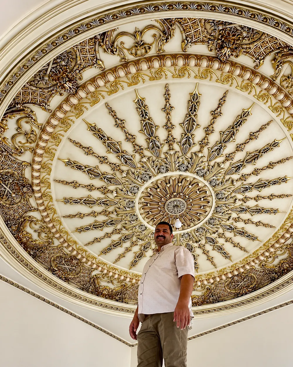 Gilded ceiling medallion radiating ornament, seen from below