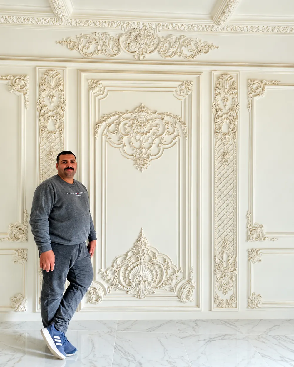 Panelled wall with carved frames, scrolls and a crest