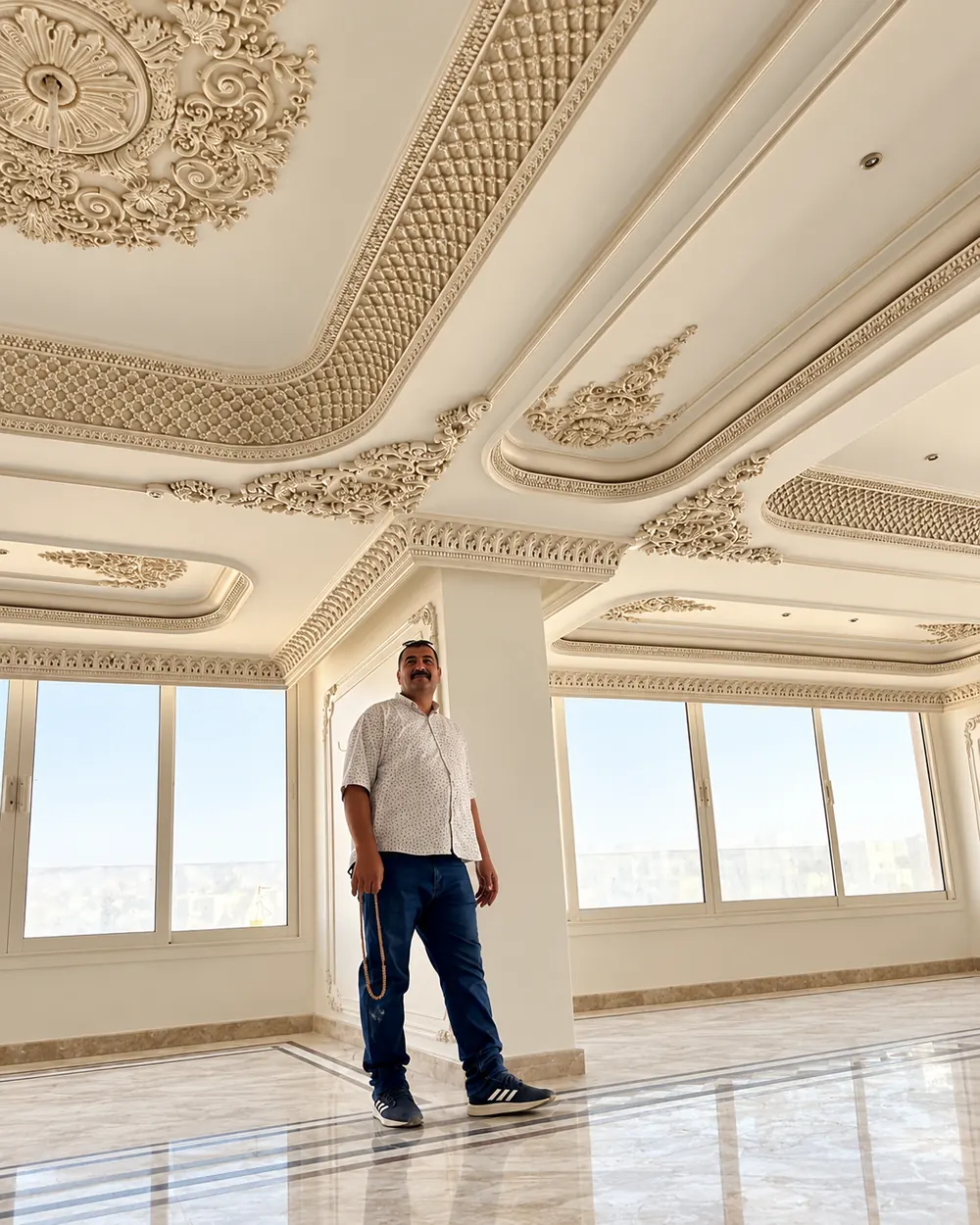 Open interior with a deep cornice and ceiling ornament