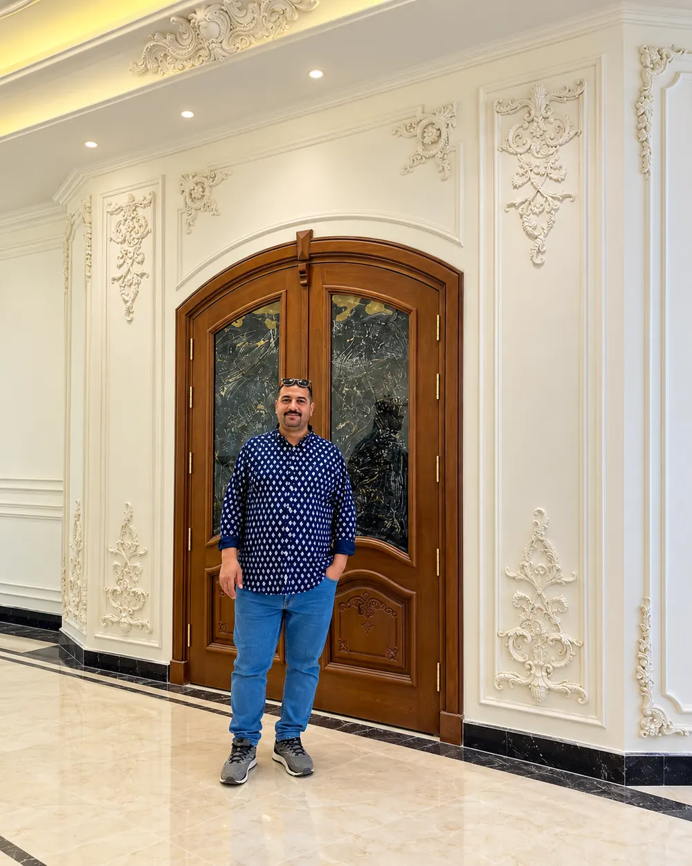 Panelled entrance hall framed around a carved timber door